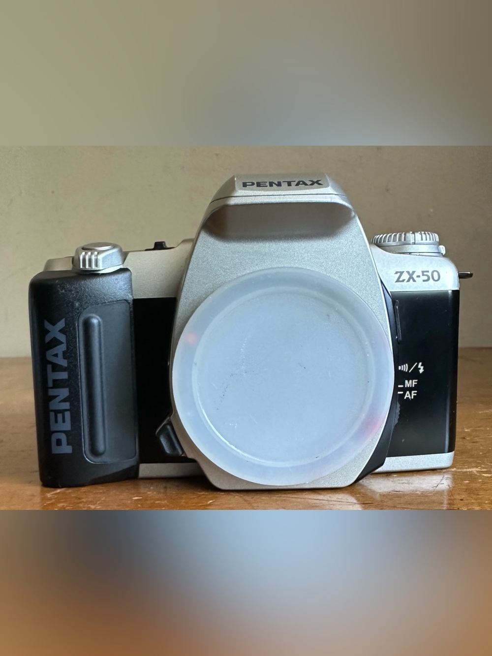 Pentax Silver SLR Camera Body with White Lens Cap